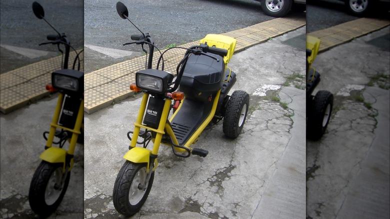 honda road fox minibike scooter parked sidewalk