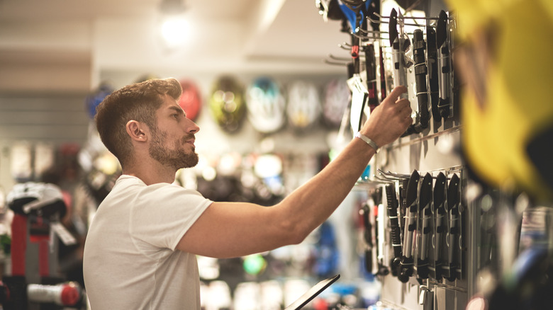 Man shopping in hardware store for tools