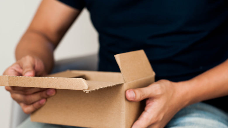 Man opening cardboard box