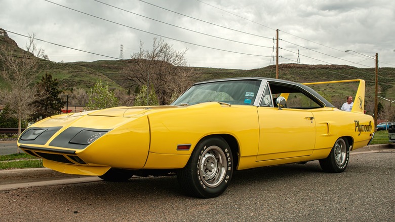 Yellow Plymouth Superbird parked at roadside