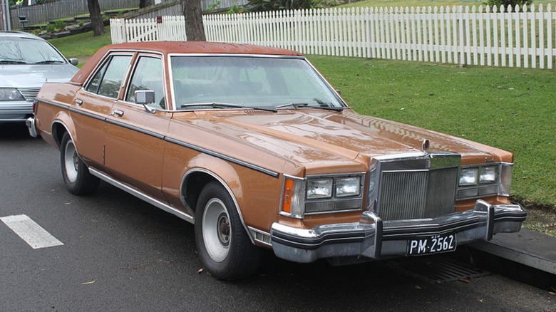 Orange Lincoln Versailles parked on the street