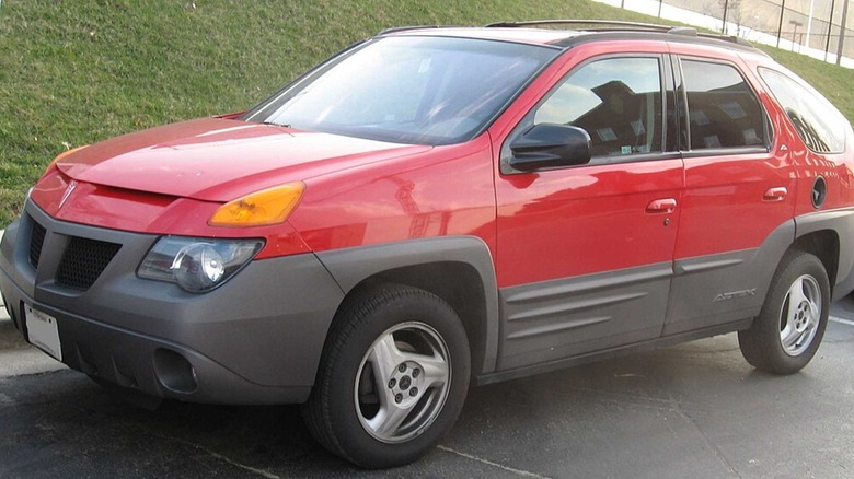 Red Pontiac Aztek parked sideways