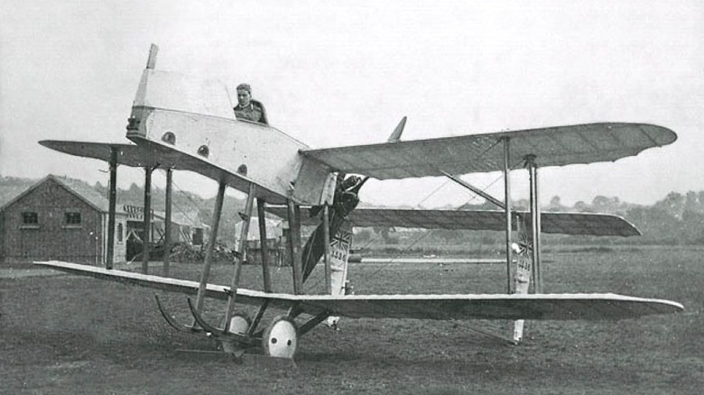 Photo of AD Scout aircraft with pilot in field