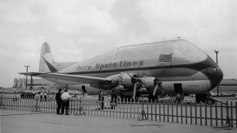 Aero Spacelines Pregnant Guppy black and white photo behind fence