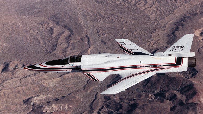 Grumman X-29 flying over desert terrain