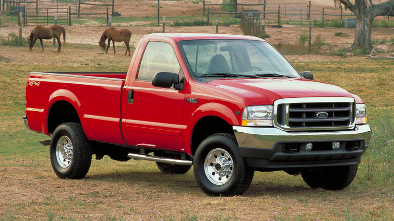 The 1999 Ford F-350 single cab in red, front 3/4 view