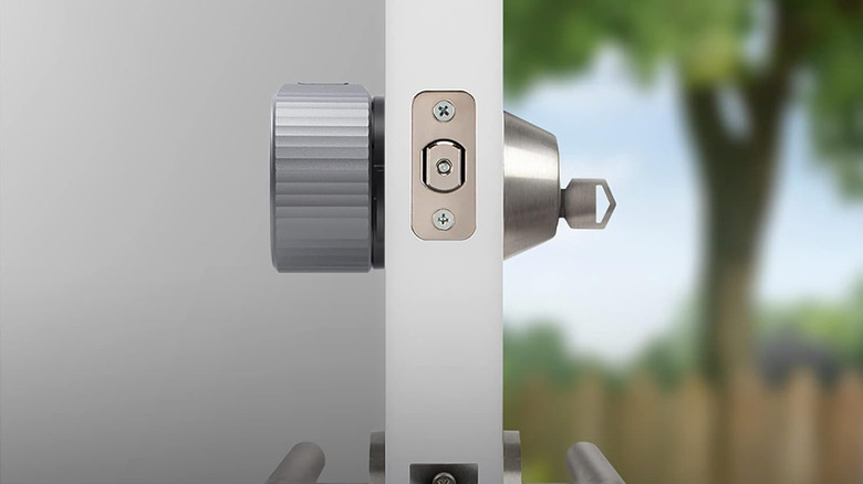 An August smart lock as seen from the side on a door