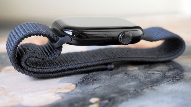 An Apple Watch 10 on a table with its banded folded