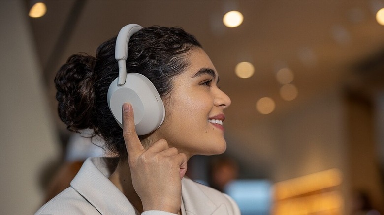 Woman wearing Sony WH-1000XM5 headphones