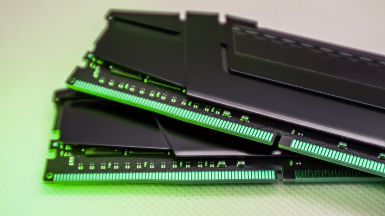 Two sticks of RAM bathed in a green glow