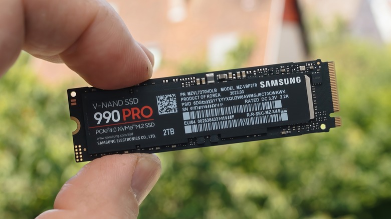 A person holding a Samsung SSD outside