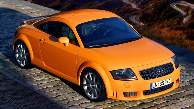 The first generation Audi TT 3.2 in orange, front 3/4 view, aerial angle