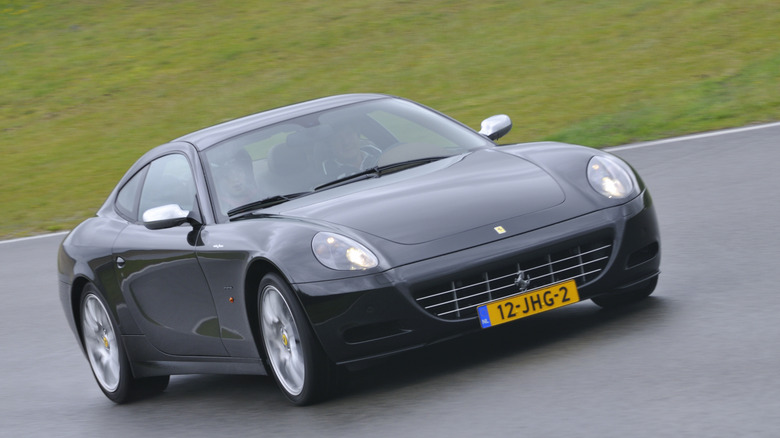 The Ferrari 612 Scaglietti in black driving, front 3/4 view