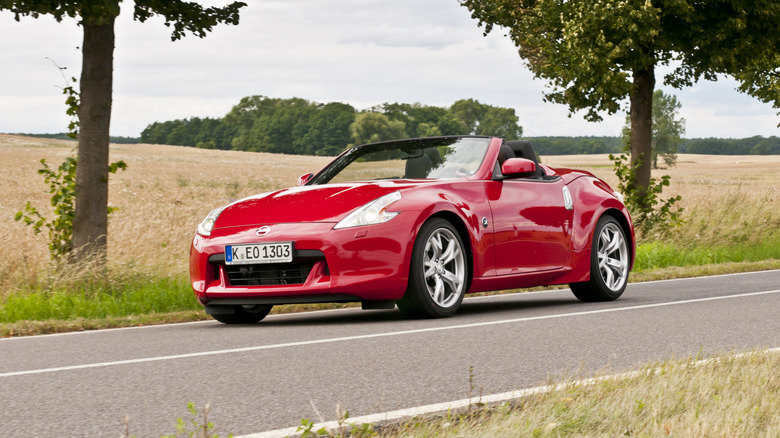 The Nissan 370Z Roadster in red driving, front 3/4 view