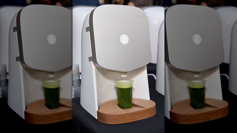 A Juicero machine making green juice