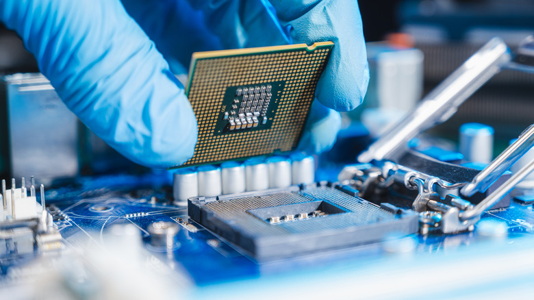 A person placing a CPU into a CPU socket