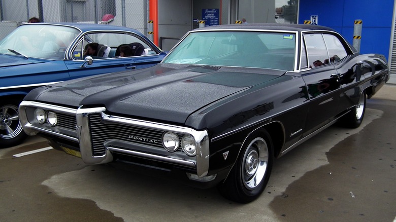 Black 1968 Pontiac Parisienne parked in rain