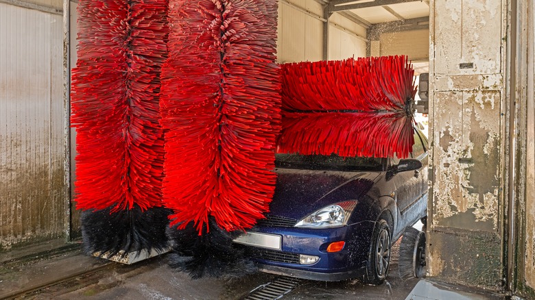 Car going through automatic wash with brushes