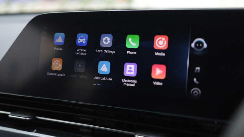 A car stereo with multiple apps and settings displayed on it