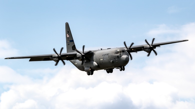 C-130 Hercules flying over cloudy skies