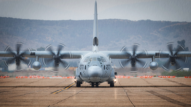 A C-130 Hercules preparing for takeoff on a runway