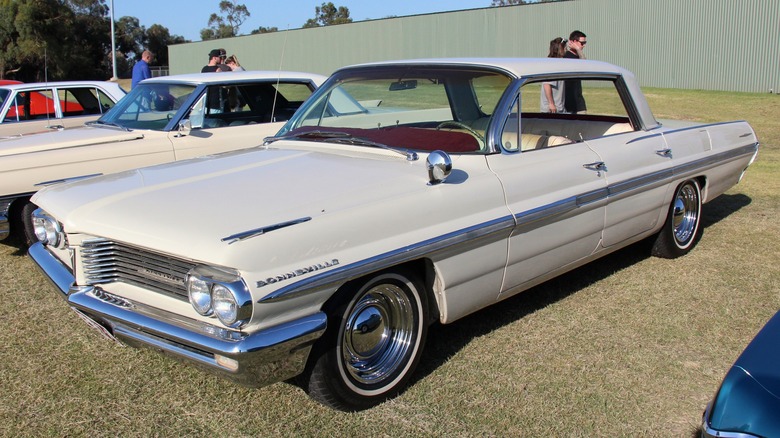 Beige 1962 Pontiac Bonneville parked on grass