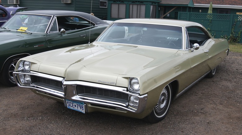 Beige 1967 Pontiac Bonneville parked on dirt