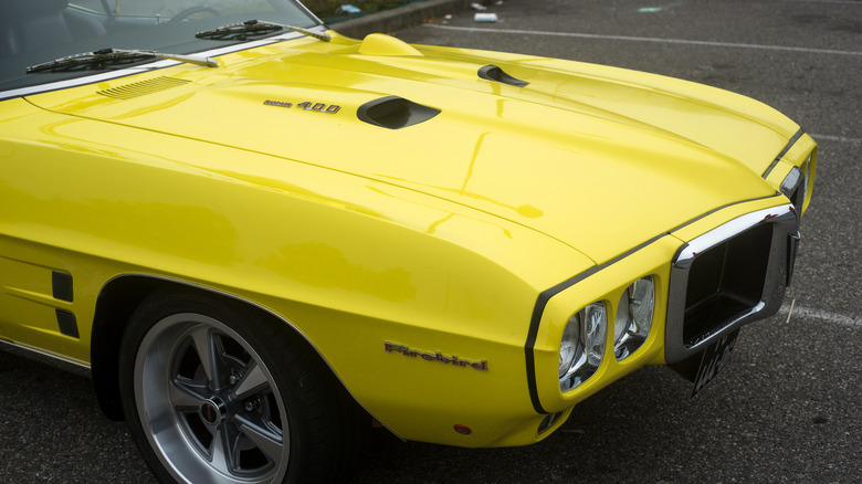 Yellow Pontiac Firebird parked