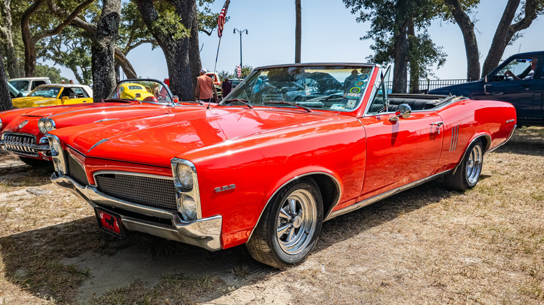 A red Pontiac Tempest LeMans at a small car show