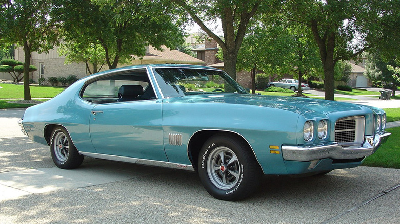 A teal blue 1971 Pontiac LeMans in a driveway