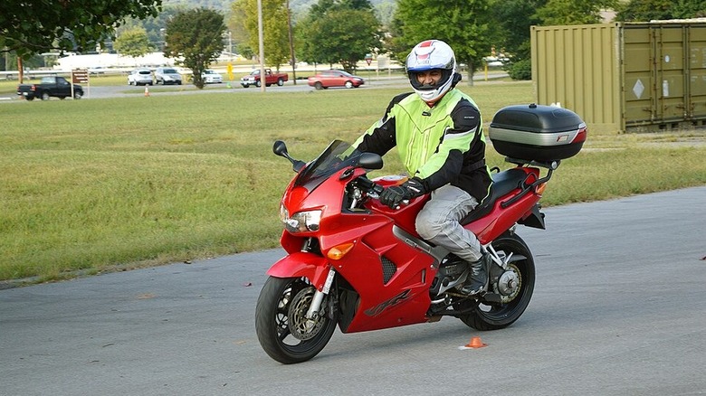 Person in full motorcycle gear on a bike