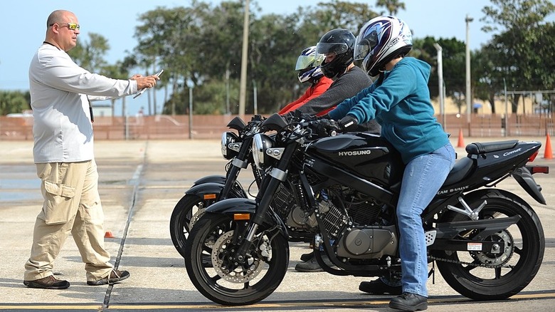 Instructor giving sailors on motorcycles directions