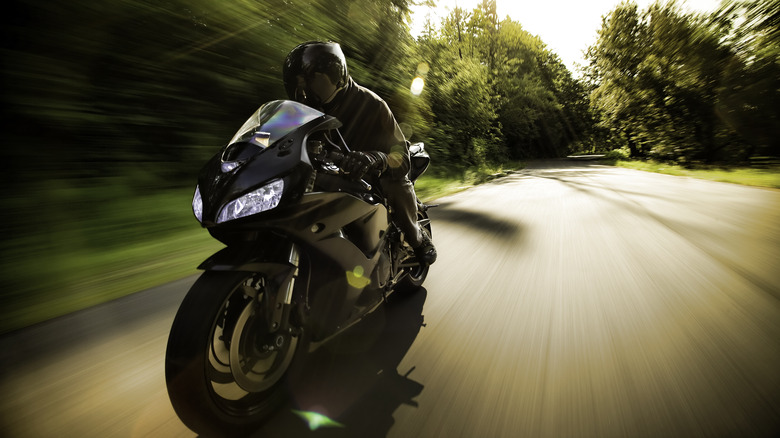 Person riding a motorcycle on a street