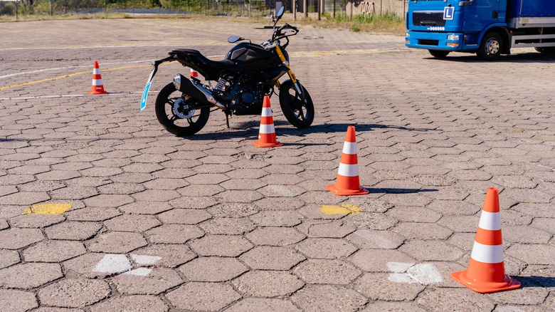 Motorcycle parked near traffic cones