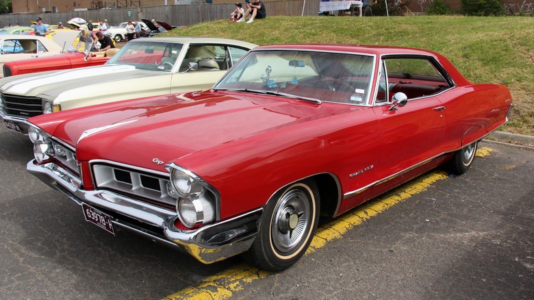 Red 1965 Pontiac Grand Prix parked