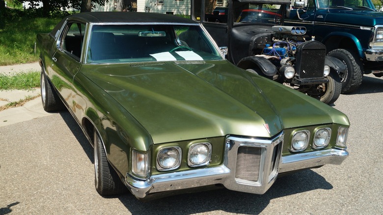 Green 1969 Pontiac Grand Prix parked