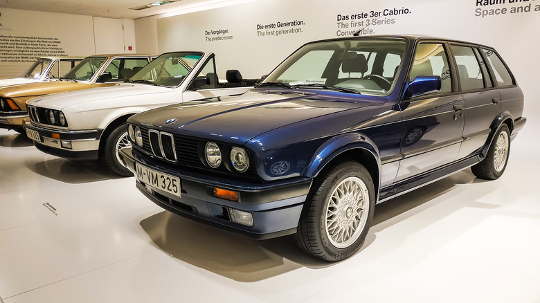 Touring and convertible E30s in a showroom