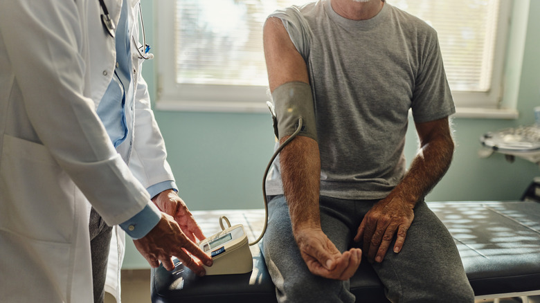 Doctor testing a patient's blood pressure