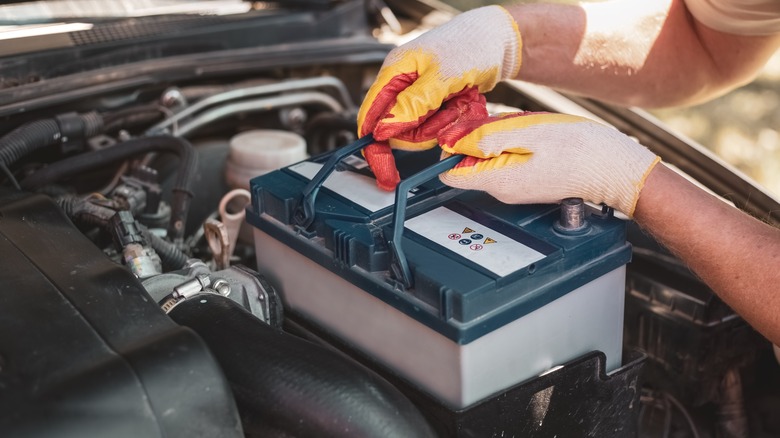 Mechanic removing car battery