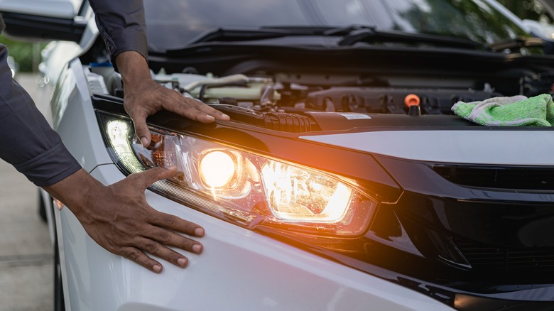 Mechanic working on car headlights