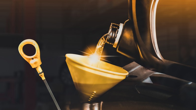 Oil being poured into car