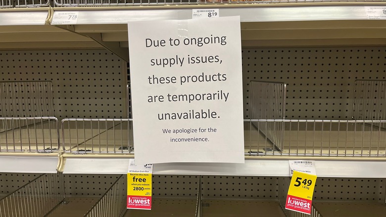 Sign explaining ongoing supply issues and unavailable products in store