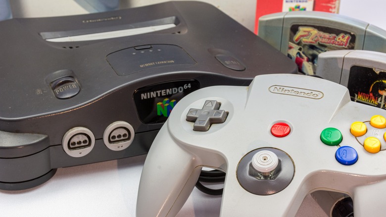 Black Nintendo 64 and grey controller