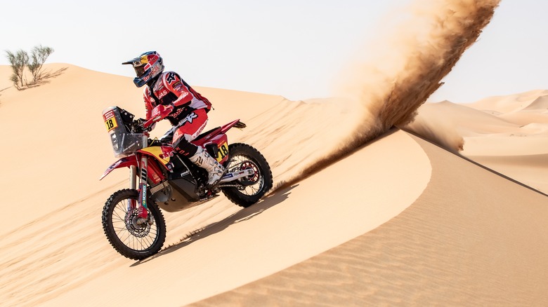 Person riding Gas Gas bike on dune