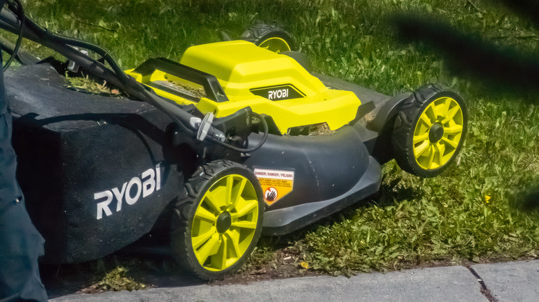 A Ryobi lawnmower on a patch of grass