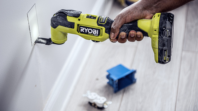 Person using Ryobi multi tool