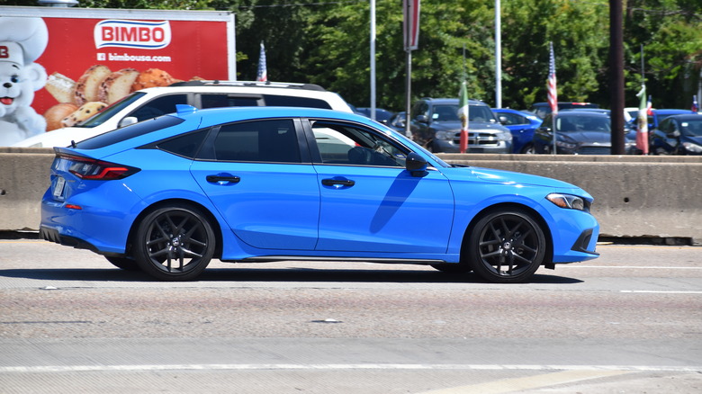 Blue Honda Accord driving down road