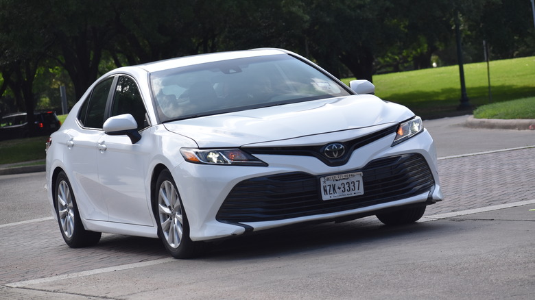 White Toyota Camry near nature reserve