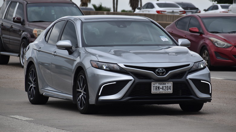 Toyota Camry driving down road