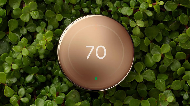 A Nest Learning Thermostat against a planet background